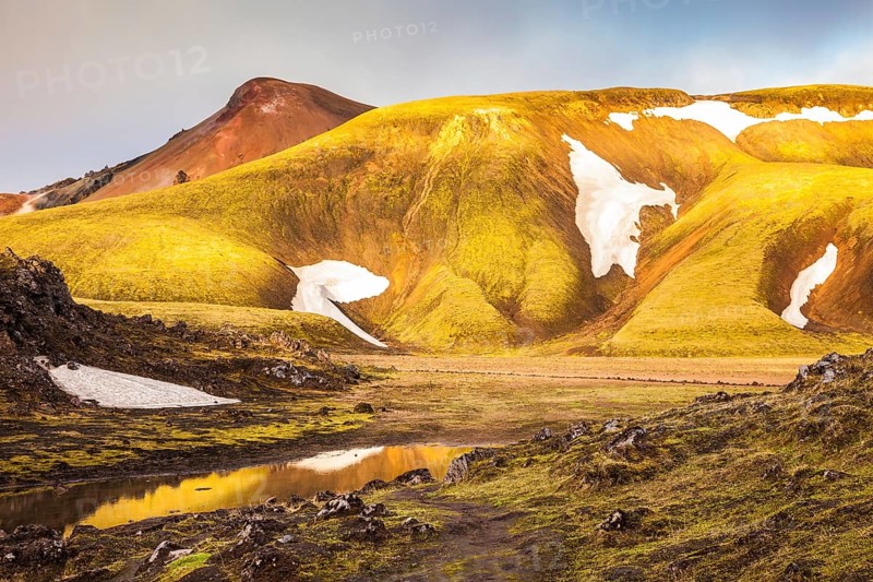 Magic sunrise in the Arctic. The golden light of dawn illuminates the mountains and glaciers national park Landmannalaugar, Iceland, Europe