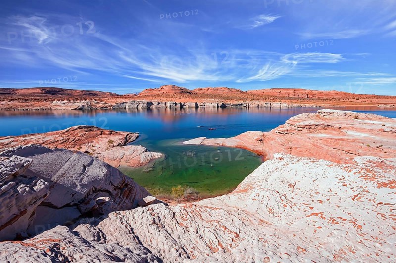 Lake Powell in the U.S. The coast is cut by narrow canyons. Grandiose huge lake of artificial origin among the picturesque red sandstone cliffs