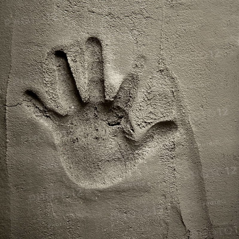 Hand print on cement mortar wall with shadow relief