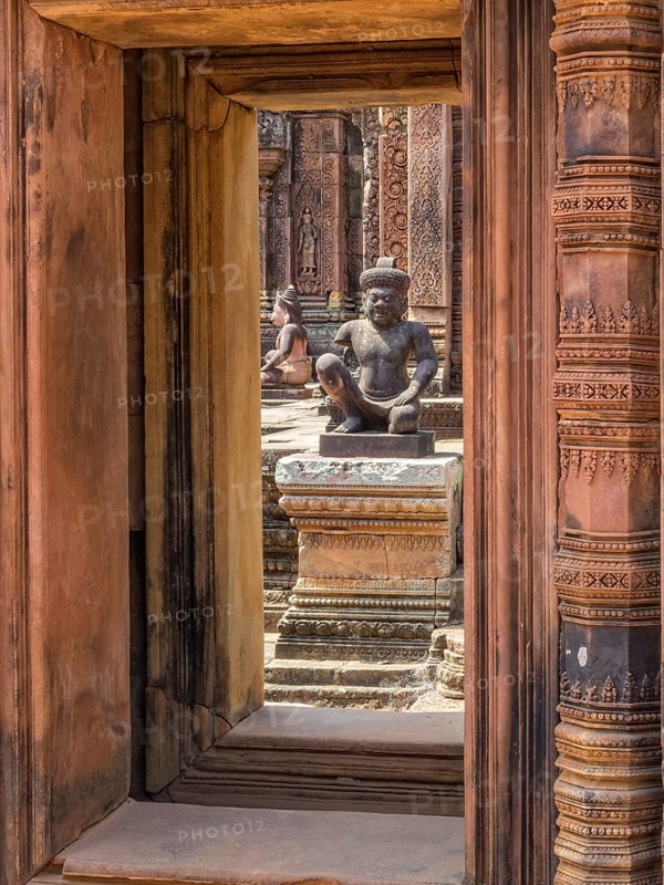 Kneeling guardians keep watch over the interior of the 'Citadel of the women', Banteay Srei, Cambodia, Asia