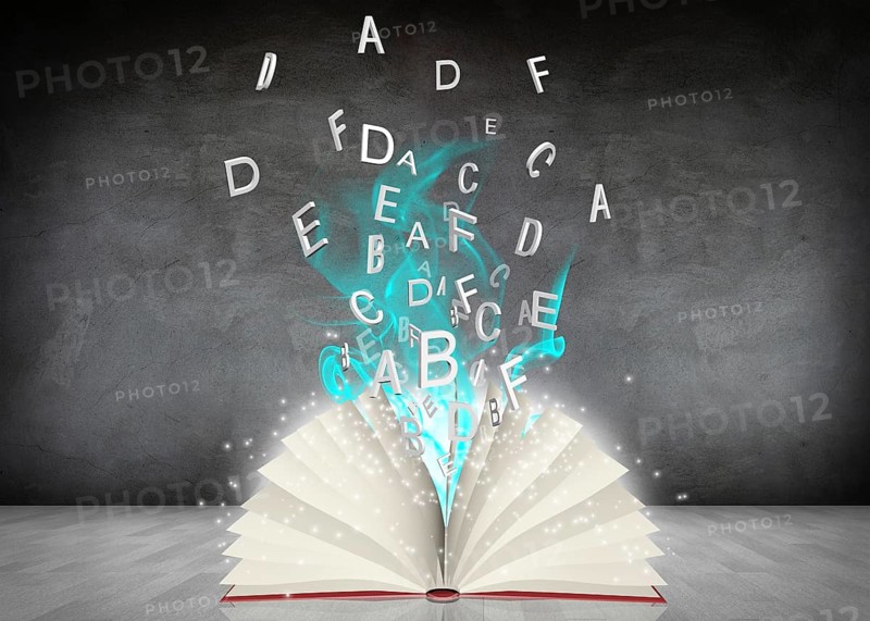 Open book with blue smoke lying in the gray room
