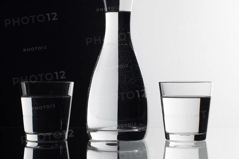 Glasses of water on the black and white background on the glass table