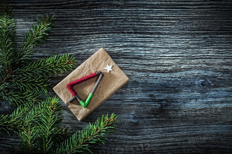 Pine tree branches gift box on wooden board