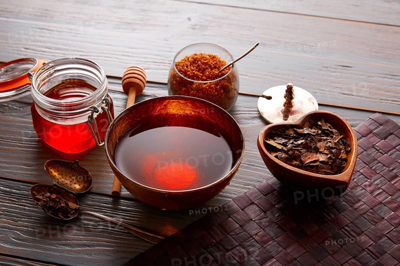 Bancha tea served in golden bowl on wooden table board