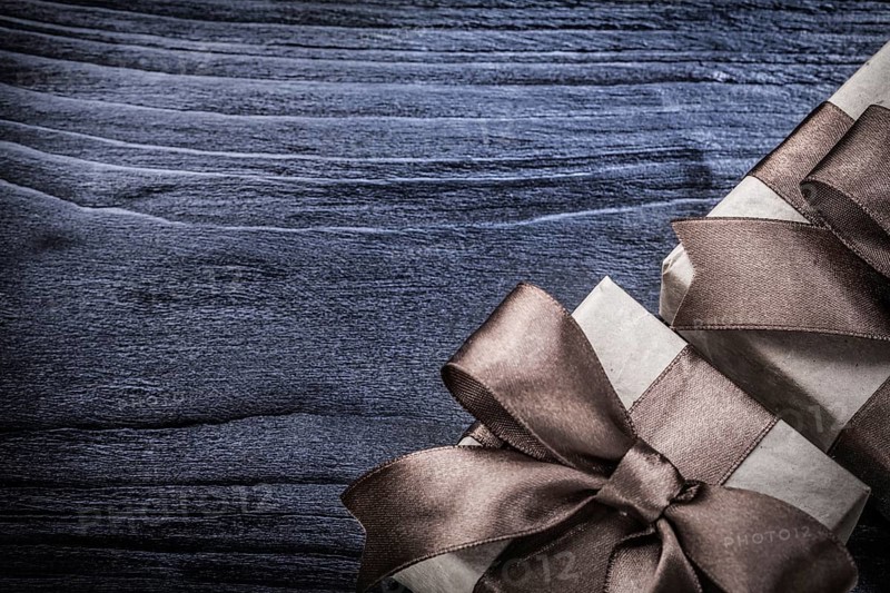 Wrapped gift boxes on wooden board holidays concept