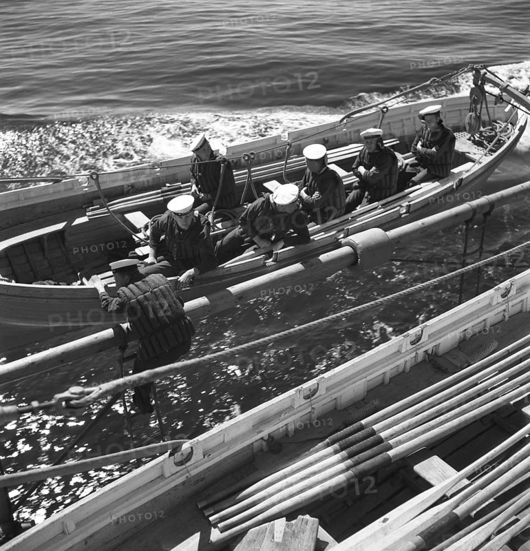 During World war II. The war ship Sverige during navy exercises at sea. The life boat is being fitted and the sailors sit ready to be lowered down in the water. Sweden june 1940. Kristoffersson ref 141