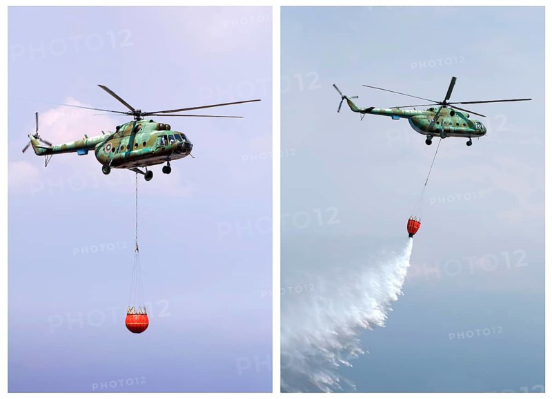 Helicopter extinguish fire with water tank