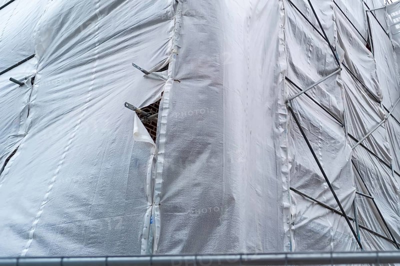 Building covered with a tarpaulin