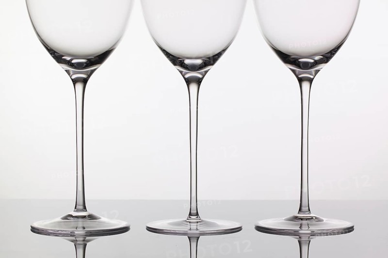 Three empty glasses of wine on a clean background