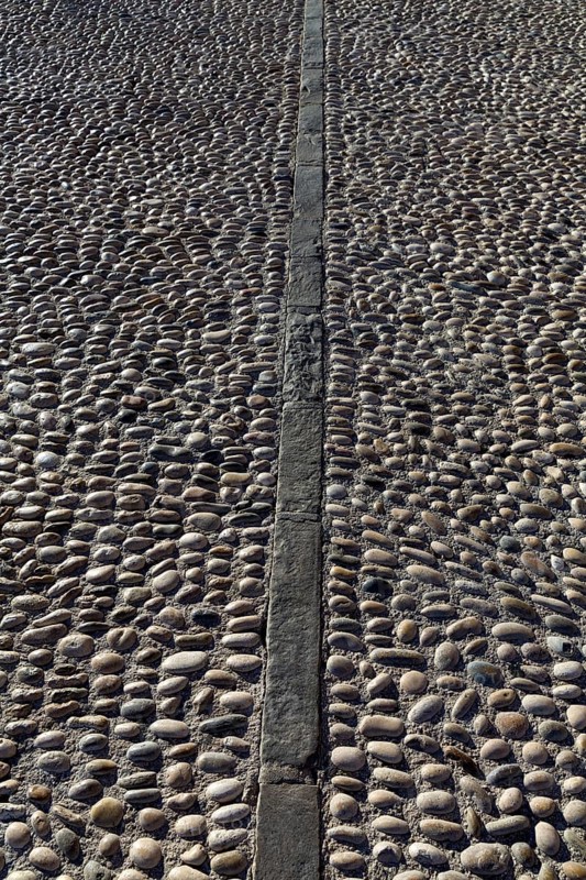 Rolling stones pavement soil texture in Altea Alicante mediterranean village of Spain