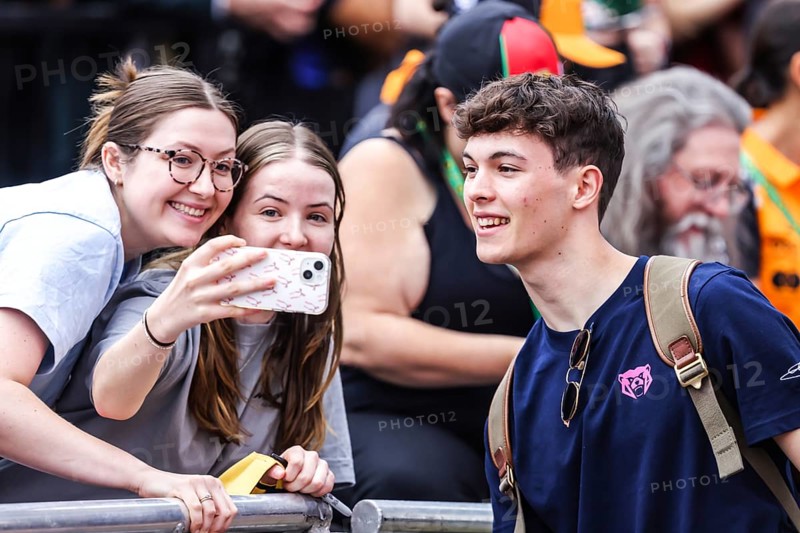 MELBOURNE, AUSTRALIA - MARCH 13: Oliver Bearman of Great Britain and MoneyGram Haas F1 Team with fans before the 2025 Australian Grand Prix at Albert Park in Melbourne, Australia, Oceania