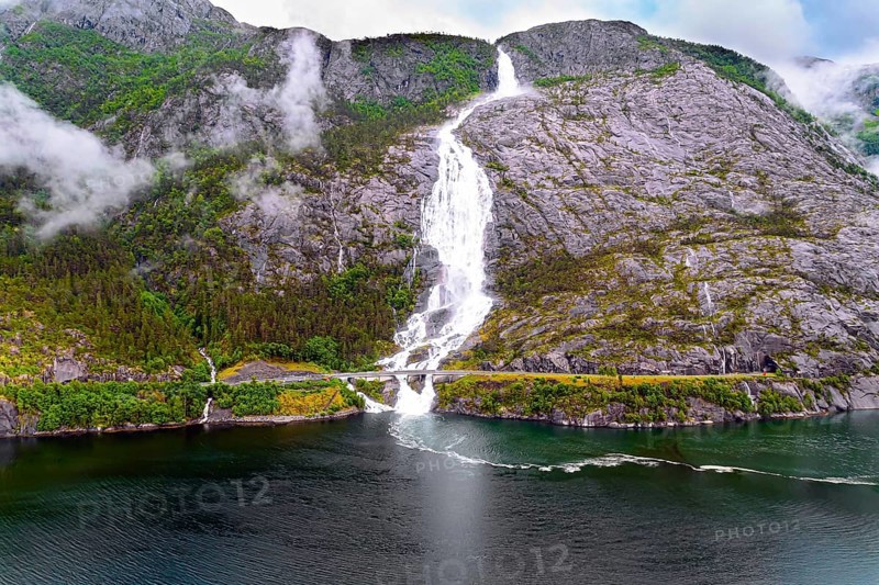 Langfossen cascade waterfall on the Vaule river. Western Norway. Passes through the highway. The photo was taken with a drone. Summer cold and rainy day