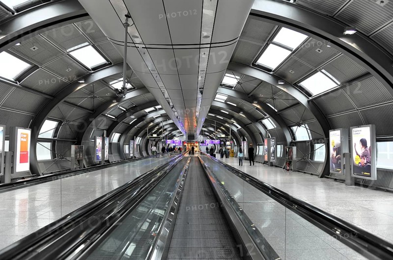 Frankfurt Airport, Frankfurt am Main, Hesse, Germany, Europe, Futuristic airport tunnel with escalators, illuminated and with some passengers in the background, Yucatán region, Mexico, Central America, Europe