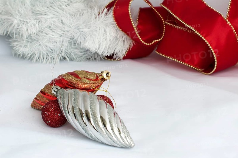 Christmas motifs with balls and chains. Red and white balls, white chains and red ribbon