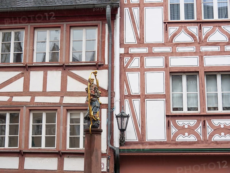 Half-timbered wall with statue of the Virgin Mary standing next to a street lamp post, mainz, rhineland-palatinate, Germany, Europe