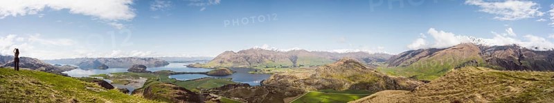 View over a wide mountain landscape with lakes and green terrain under a clear sky, Wanaka, New Zealand, Oceania