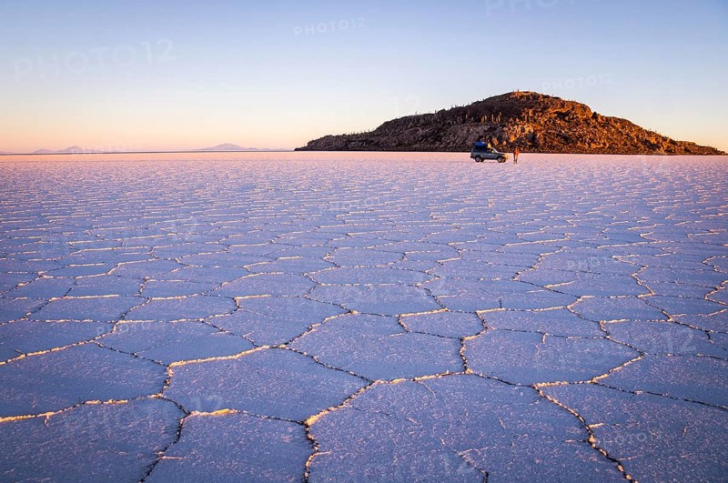 Salar Uyuni, BOLIVIA in September 2015: The sun rises over worlds largest salt lake Salar de Uyuni. Southwestern Bolivia is well-known for dramatic landscapes, lagunas, geysers and deserts