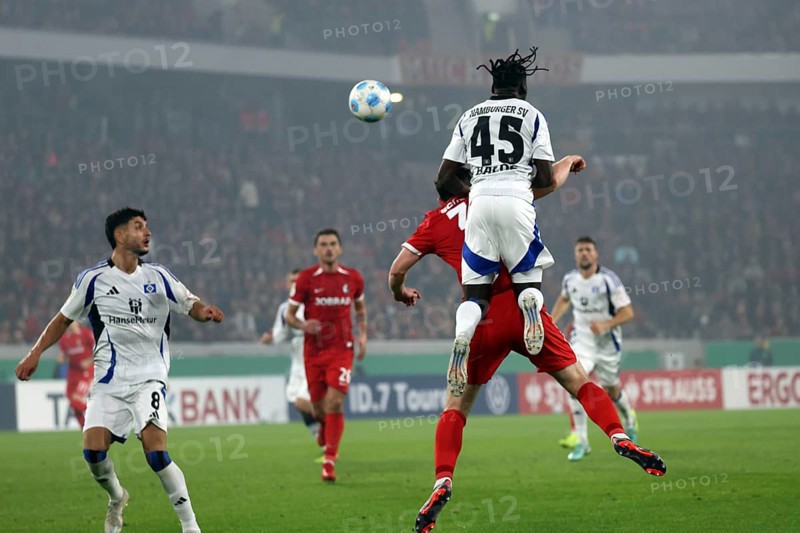 Fabio Baldé (HSV) leaps over a header by Michael Gregoritsch (SC Freiburg) during the match for the DFB Cup 2024-25, 2nd round: SC Freiburg vs Hamburger SV, Freiburg im Breisgau, Germany / Germany