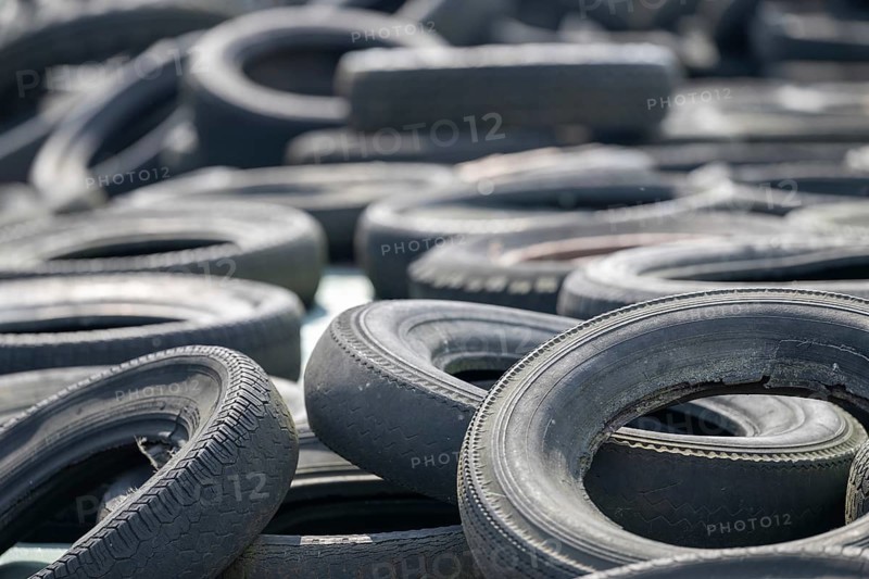 Old car tires on silaged fodder on a dairy farm