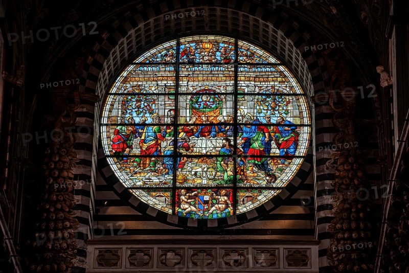 SIENA, ITALY, SEPTEMBER 23, 2023, Rich ornate window of the nave of the Siena Cathedral in Italy, showing the Last Supper of Christ