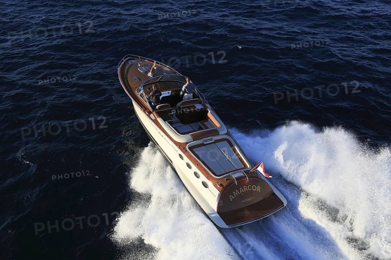 Aerial view sports boat J Craft 42 Torpedo R at full speed on the Cote d'Azur, luxurious motorboat from the Swedish shipyard J Craft Boats with Volvo Penta engine in vintage style of the 50s and 60s in the style of the Riva boats, Mediterranean Sea