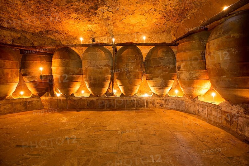 Antique winery in Spain with clay vessels terracotta amphora pots Mediterranean tradition with candlelight