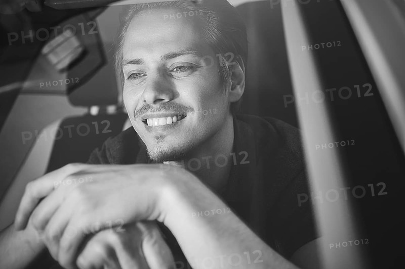 Enjoy the drive. Image of young handsome guy sitting in car