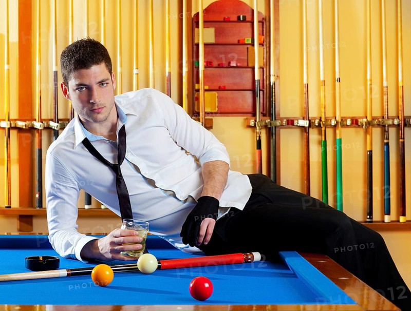 Billiard handsome player man drinking some alcohol in club