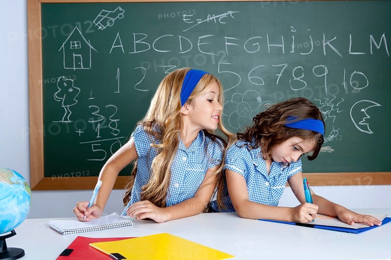 Classroom with two kids students cheating on test exam at school