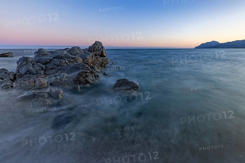 Rocks in the sea on the beach of Torre di Bari at sunset, long exposure, Torre di Bari, Bari Sardo, Ogliastra, Sardinia, Italy, Europe