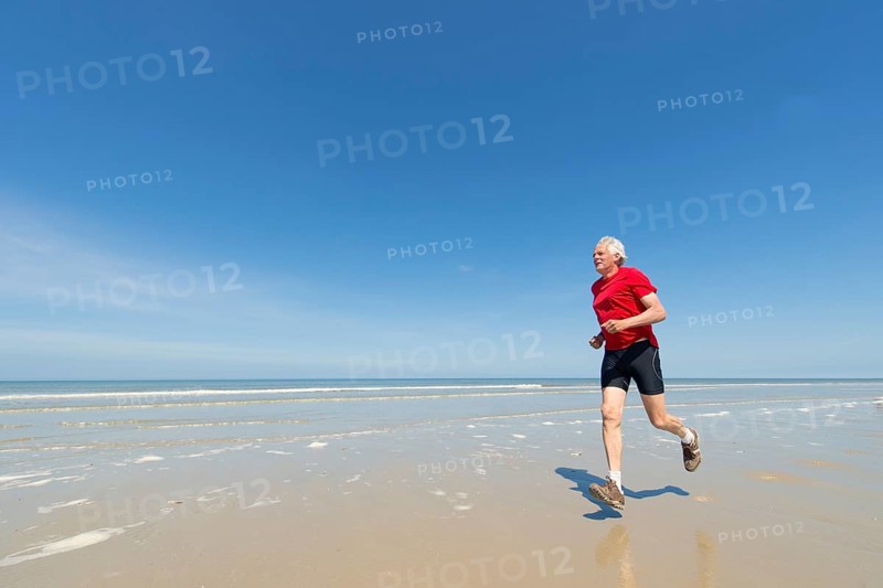 Elder man running at the beach