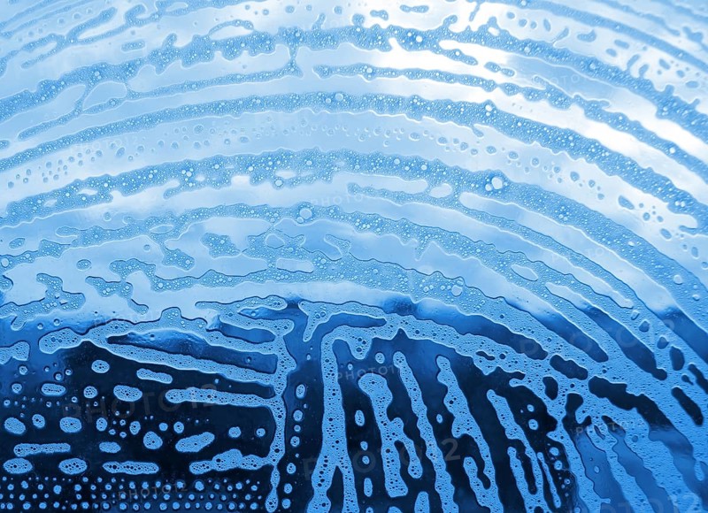 Soap foam bubbles on the glass
