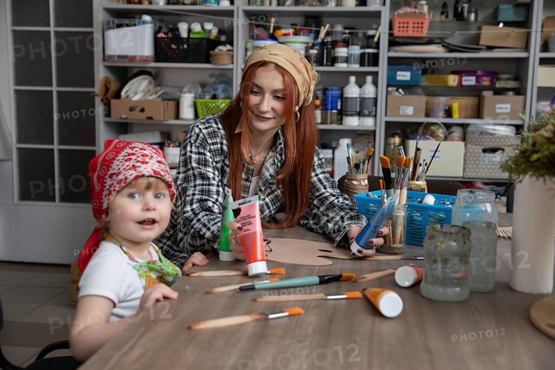 A delightful art session where a mother and child engage in creative activities, showcasing bonding and joy