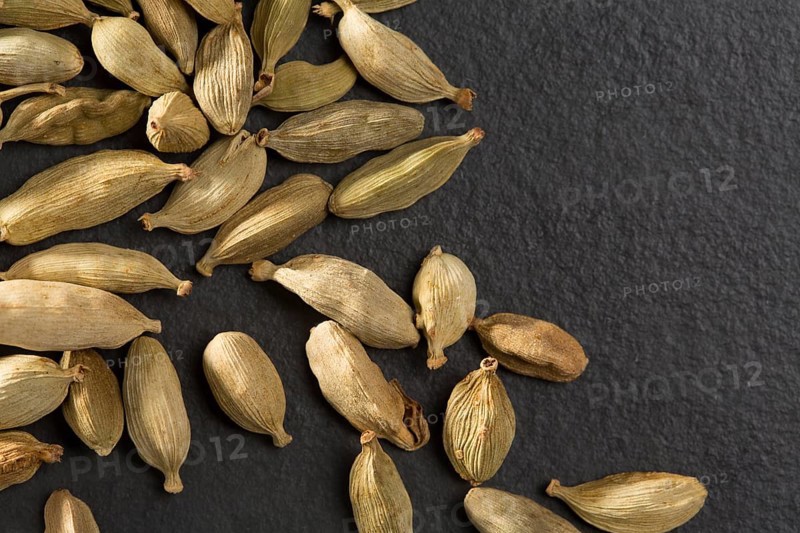 Cardamom pods on black background macro closeup