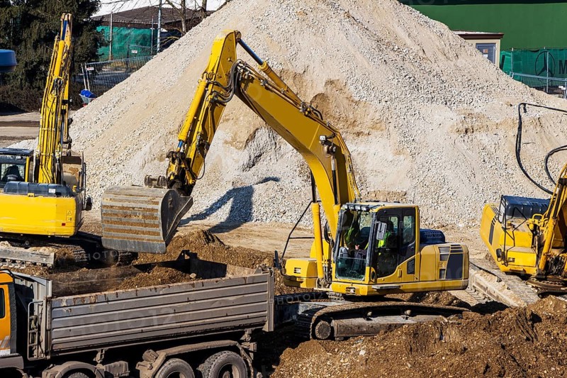 Excavator on a building site. Excavator shovel with earth, earthworks. Austria