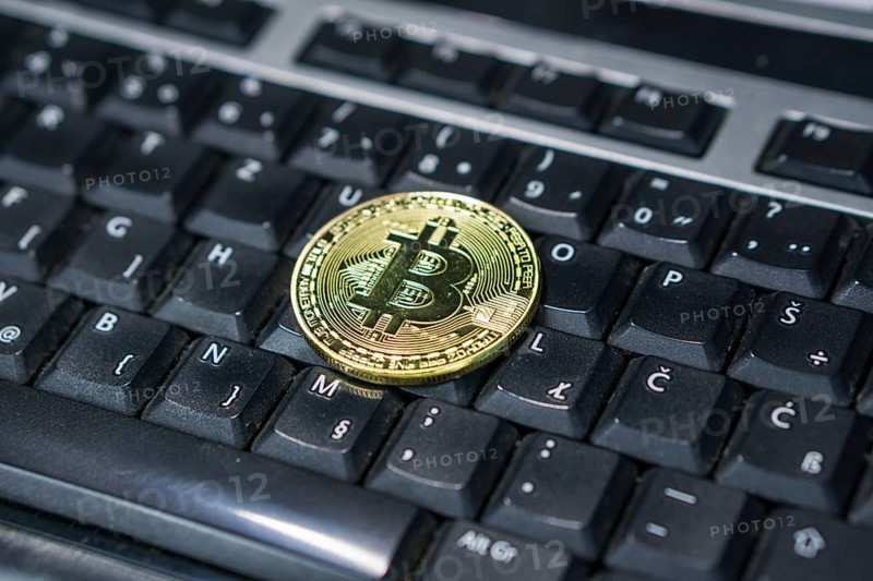 Background with bitcoin on the keyboard
