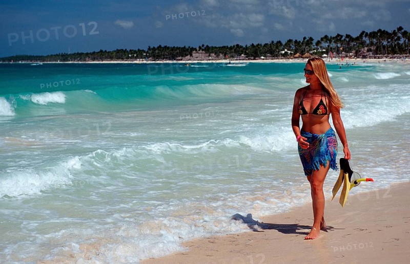 Woman strolling on a sandy beach, Catalina Island, Caribbean, Dominican Republic, Central America