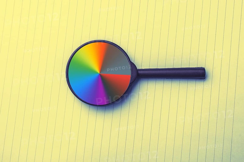 Looking through a magnifying glass to documents. Concept of search