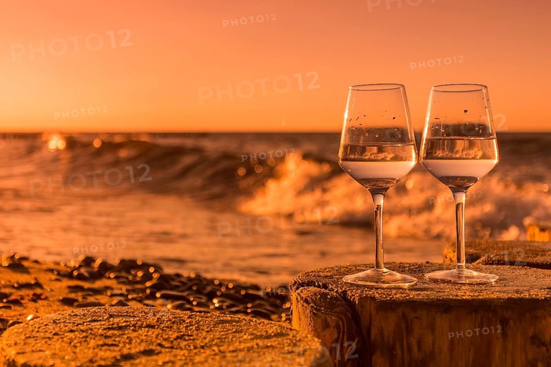 Wine on the baltic sea beach at sunset