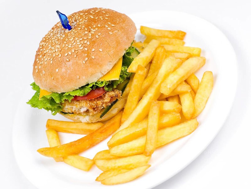 A cheeseburger with deep fried potatoes, closeup