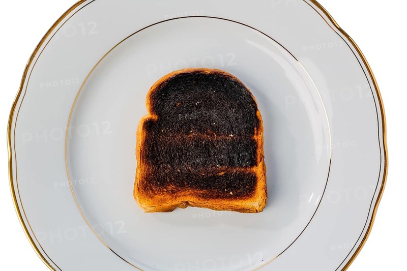 Toast was burnt during toasting. Burnt slices of toast at breakfast. Austria