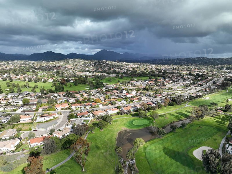 Aerial view of residential neighborhood surrounded by golf and valley during cloudy day in Rancho Bernardo, San Diego County, California. USA