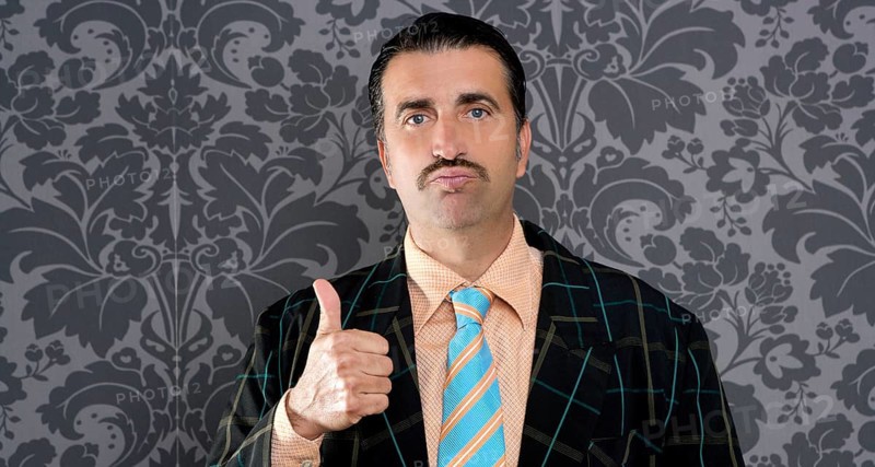Nerd businessman gesturing ok positive with hand over retro wallpaper
