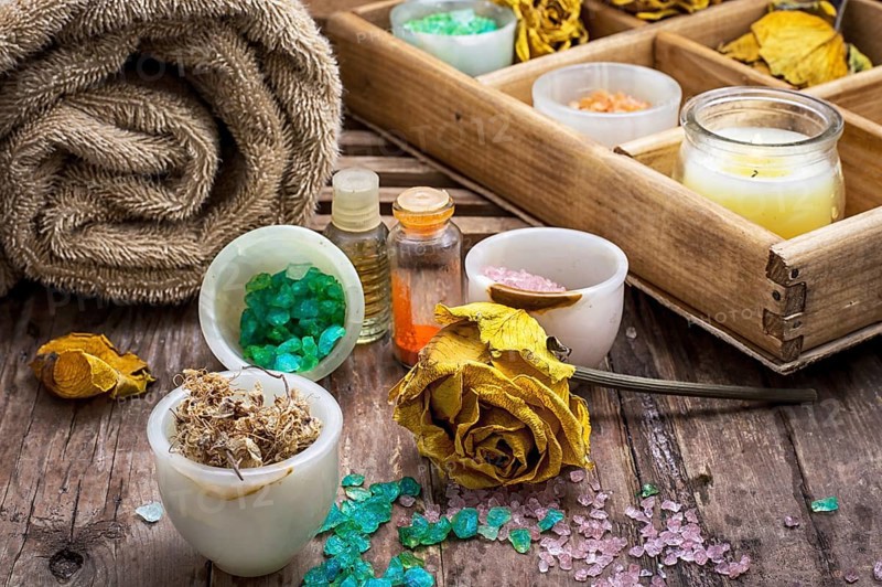 Sea aromatic salt for Spa treatments on the background of yellow rose buds