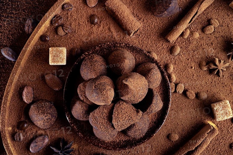 Healthy delicious chocolate truffles around ingridients with natural cocoa beans, powder, cacao butter, cane sugar. healthy sweets concept. close up. flat lay