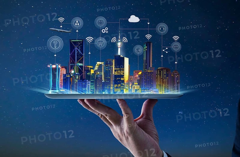 Waiter hand holding an empty digital tablet with Smart city with smart services and icons, internet of things, networks and augmented reality concept, night scene