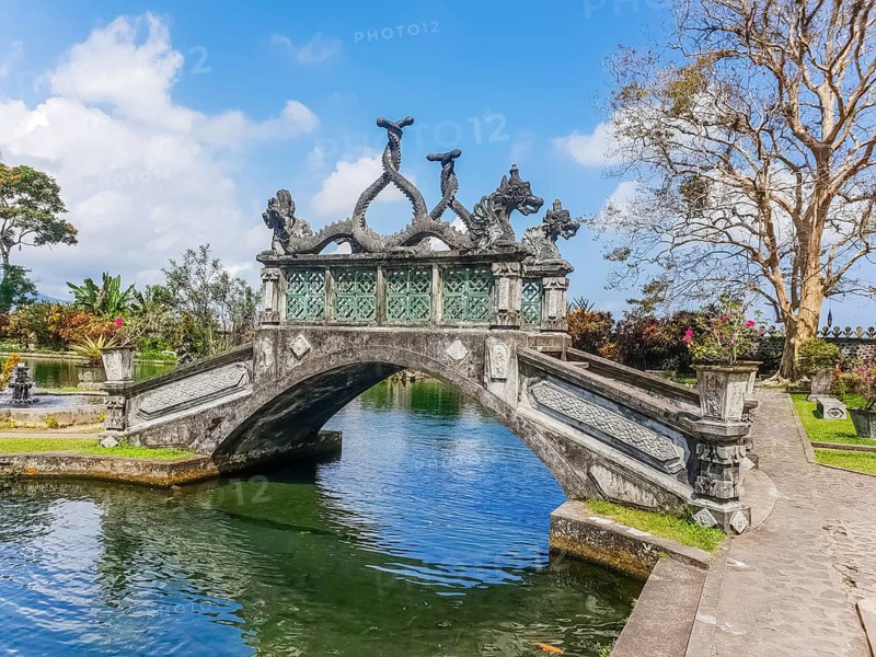View of bridge in park in Tirta Gangga temple at sunny day in Bali, Indonesia, Asia