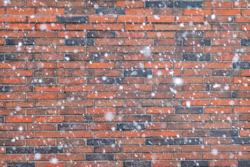 Snowflakes in front of a brick wall