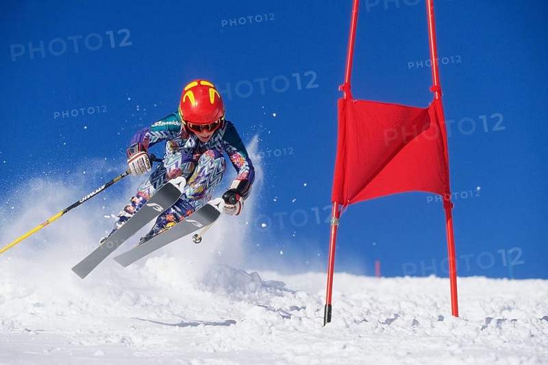 Skiers in action, descent on a slope, deep snow