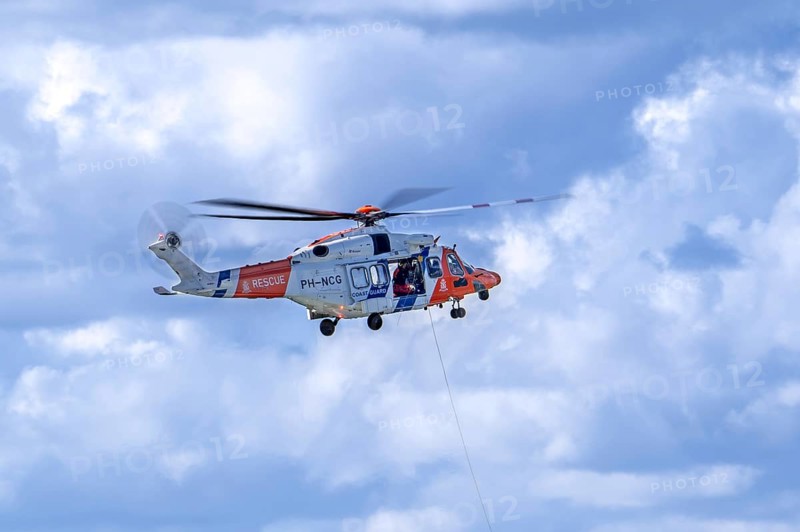 AgustaWestland AW189 rescue helicopter PH-NCG of the Nederlandse Kustwacht, Dutch Coastguard flying along the North Sea coast, Netherlands